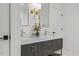 Elegant primary bathroom featuring double sink vanity, stylish sconces and neutral decor at 42 Turkey Ct, Timberlake, NC 27583