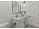 Modern bathroom featuring double sinks, quartz counters, and geometric tile floors at 42 Turkey Ct, Timberlake, NC 27583