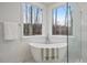 Bright and airy bathroom features a freestanding tub near a window offering a view, and a glass enclosed shower at 42 Turkey Ct, Timberlake, NC 27583