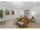 Bright bedroom featuring a chandelier, decorative wainscoting, two windows and neutral decor at 42 Turkey Ct, Timberlake, NC 27583