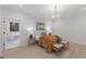 Stylish bedroom featuring wainscoting, wood-look flooring, and ensuite bathroom with soaking tub at 42 Turkey Ct, Timberlake, NC 27583