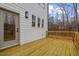 View of the house from the wood deck, with a view of the wooded backyard at 42 Turkey Ct, Timberlake, NC 27583