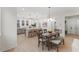 Dining area connected to the kitchen, showcasing modern lighting and plenty of natural light at 42 Turkey Ct, Timberlake, NC 27583