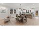 Bright dining area adjacent to the kitchen, offering modern lighting and natural views from the windows at 42 Turkey Ct, Timberlake, NC 27583