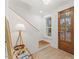 Bright entryway featuring a wooden front door, stairs, and stylish decor elements at 42 Turkey Ct, Timberlake, NC 27583