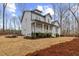 Charming two-story gray home with a welcoming front porch and landscaped with pine straw at 42 Turkey Ct, Timberlake, NC 27583