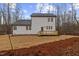 Back exterior of the home with new wood deck, new yard, and wooded lot at 42 Turkey Ct, Timberlake, NC 27583