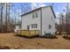 Rear exterior view of the home with a wood deck and partially seeded lawn at 42 Turkey Ct, Timberlake, NC 27583