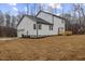 View of the rear exterior of the home, including the garage and deck, with newly seeded yard at 42 Turkey Ct, Timberlake, NC 27583