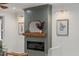 Contemporary fireplace with wooden mantle, flanked by sconces and decorative artwork at 42 Turkey Ct, Timberlake, NC 27583