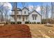 Charming two-story white home with a welcoming front porch and well-manicured lawn and landscaped with pine straw at 42 Turkey Ct, Timberlake, NC 27583
