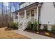 A detailed view of the home's entrance with beautiful steps, a white porch, and lush landscaping at 42 Turkey Ct, Timberlake, NC 27583