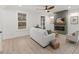 Bright living room featuring a fireplace, a ceiling fan and large windows providing natural light at 42 Turkey Ct, Timberlake, NC 27583
