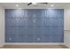 The blue accent wall with geometric panels and modern lighting fixtures creates a stylish and visually striking living space at 42 Turkey Ct, Timberlake, NC 27583