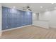 The living room boasts a blue accent wall, wood floors, modern lighting, and a neutral color palette at 42 Turkey Ct, Timberlake, NC 27583