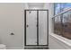 This tiled shower features a black trim and a glass door at 42 Turkey Ct, Timberlake, NC 27583