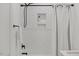 This updated shower features white herringbone tiling, black hardware, and niche shelving at 42 Turkey Ct, Timberlake, NC 27583