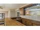 Close-up of finished basement bar featuring wooden cabinets, sink, and mirrored backsplash at 450 S Stratford Dr, Henderson, NC 27537