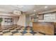 Finished basement with checkerboard flooring, bar area, storage, and drop ceiling at 450 S Stratford Dr, Henderson, NC 27537
