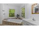 Inviting bathroom featuring a tiled tub, a large window, and a sink at 450 S Stratford Dr, Henderson, NC 27537