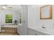 Bright bathroom features double sinks, tub with tile surround, and natural light at 450 S Stratford Dr, Henderson, NC 27537