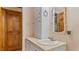 Bathroom featuring a white sink and a decorative framed mirror with cabinet storage at 450 S Stratford Dr, Henderson, NC 27537