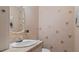 Bathroom vanity features a decorative mirror, faucet, and wall decor at 450 S Stratford Dr, Henderson, NC 27537