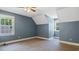 Bedroom featuring blue walls, a ceiling fan, and natural light from two windows at 450 S Stratford Dr, Henderson, NC 27537