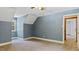 A charming bedroom features neutral carpet, an abundance of natural light, and a light blue color palette at 450 S Stratford Dr, Henderson, NC 27537