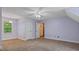 Spacious bedroom features neutral walls, carpet, ceiling fan, and natural light at 450 S Stratford Dr, Henderson, NC 27537