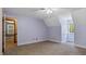Bedroom features a neutral walls, carpet, natural light, and an open doorway at 450 S Stratford Dr, Henderson, NC 27537