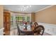 Elegant dining room with a large window and classic wood furniture at 450 S Stratford Dr, Henderson, NC 27537