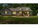 Charming home exterior featuring dormer windows and a welcoming front porch with steps at 450 S Stratford Dr, Henderson, NC 27537