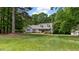 Lovely home with a well-manicured lawn and mature trees, providing a serene setting at 450 S Stratford Dr, Henderson, NC 27537