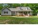 Charming home with a covered front porch, dormer windows, and a well-maintained lawn at 450 S Stratford Dr, Henderson, NC 27537