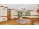 Bright living room with hardwood floors, ceiling fan, and view of front yard at 450 S Stratford Dr, Henderson, NC 27537