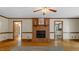 Cozy living room with a brick fireplace and hardwood floors, perfect for relaxing at 450 S Stratford Dr, Henderson, NC 27537