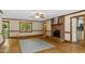 Warm living room with a brick fireplace, hardwood floors, and multiple access points at 450 S Stratford Dr, Henderson, NC 27537
