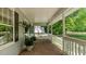 Charming covered front porch featuring brick flooring and ample space for relaxing at 450 S Stratford Dr, Henderson, NC 27537