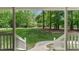Inviting view from the porch out to the lush green lawn and mature trees at 450 S Stratford Dr, Henderson, NC 27537