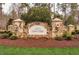 Stone entrance to The Estates at Laurel Ridge with manicured landscaping and elegant lighting at 481 Brook Green Ln # 23, Pittsboro, NC 27312