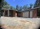 Contemporary home with a mix of stone and wood, featuring modern design elements and a flat, gravel yard at 481 Brook Green Ln # 23, Pittsboro, NC 27312