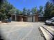 Contemporary home with a mix of stone and wood, featuring modern design elements and a flat, gravel yard at 481 Brook Green Ln # 23, Pittsboro, NC 27312