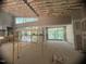 Large open-concept living room with scaffolding, large windows, and high ceilings with exposed rafters at 481 Brook Green Ln # 23, Pittsboro, NC 27312