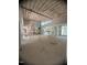 Large open-concept living room with scaffolding, large windows, and high ceilings with exposed rafters at 481 Brook Green Ln # 23, Pittsboro, NC 27312