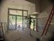 Bright, open-concept living room with high ceilings, large windows, and access to an outdoor patio at 481 Brook Green Ln # 23, Pittsboro, NC 27312