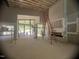 Large open-concept living room with scaffolding, large windows, and high ceilings with exposed rafters at 481 Brook Green Ln # 23, Pittsboro, NC 27312