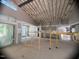 Large open-concept living room with scaffolding, large windows, and high ceilings with exposed rafters at 481 Brook Green Ln # 23, Pittsboro, NC 27312