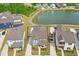 Aerial view of homes in a community surrounding a picturesque lake with walking trails at 5009 Megara, Raleigh, NC 27603