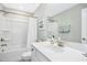 Clean bathroom with a tub shower, vanity and framed mirror at 5009 Megara, Raleigh, NC 27603